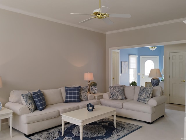 living area with ornamental molding and a ceiling fan