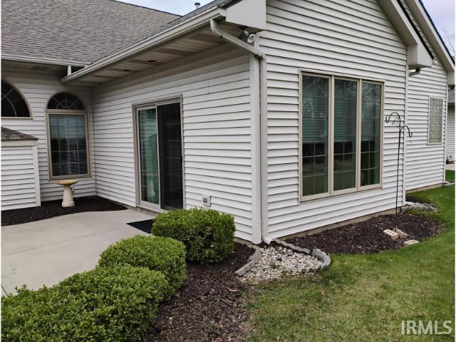 view of home's exterior featuring a yard and a shingled roof