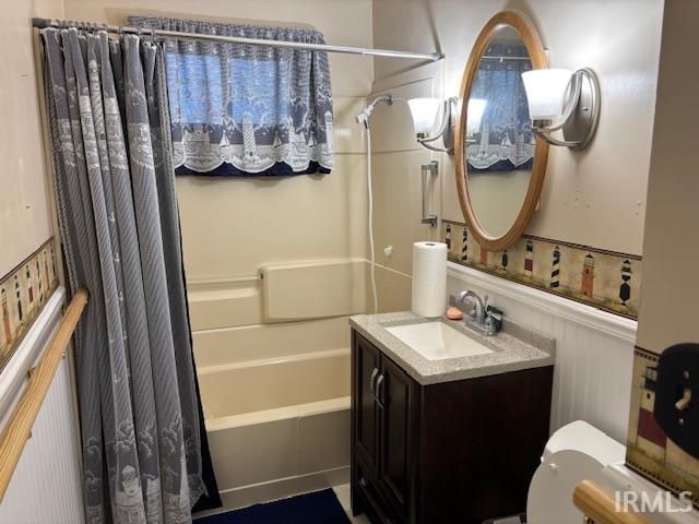 bathroom with vanity, toilet, and shower / bath combo with shower curtain