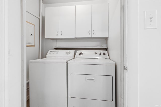 laundry area featuring washer and clothes dryer and cabinet space