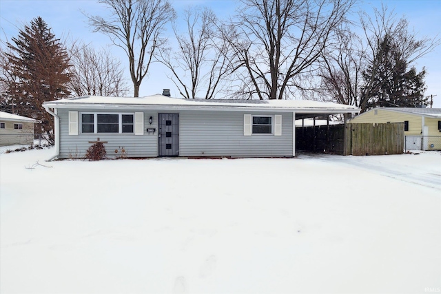 ranch-style house with fence and an attached carport