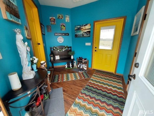 interior space with baseboards and wood finished floors