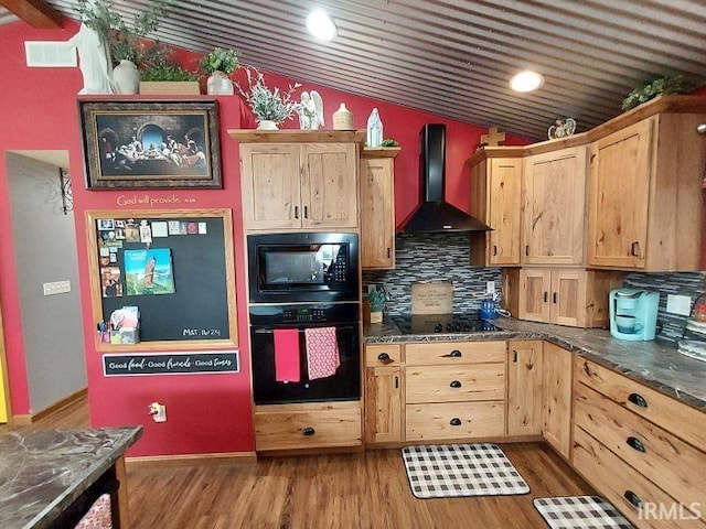 kitchen with visible vents, dark wood finished floors, wall chimney exhaust hood, vaulted ceiling, and black appliances