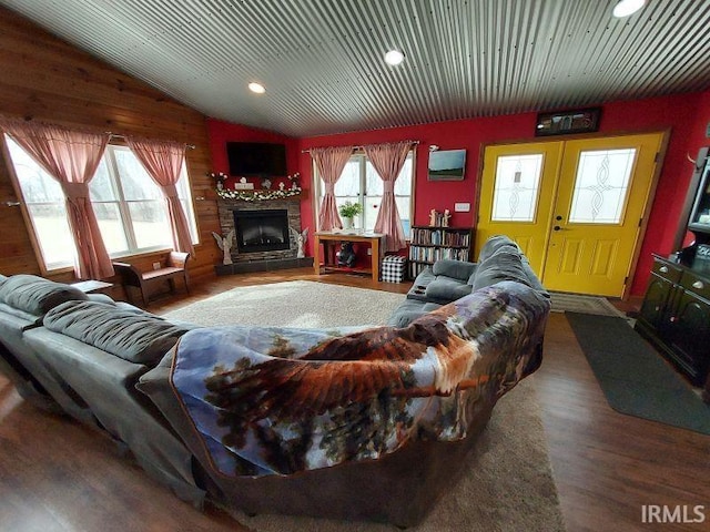 living area with lofted ceiling, a fireplace, recessed lighting, and wood finished floors