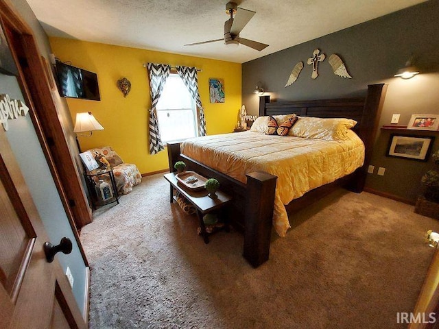 carpeted bedroom featuring a textured ceiling and ceiling fan