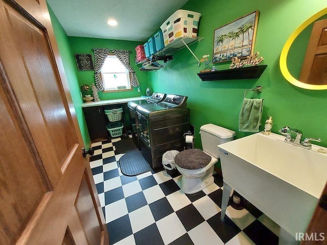 bathroom featuring a sink, toilet, and tile patterned floors