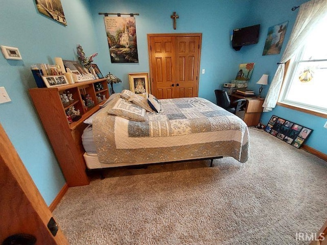 bedroom with carpet and baseboards