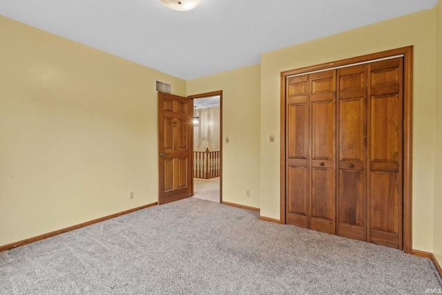 unfurnished bedroom with light carpet, visible vents, and baseboards