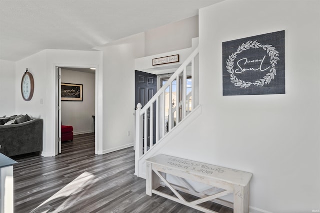 entryway with dark wood finished floors, stairway, and baseboards