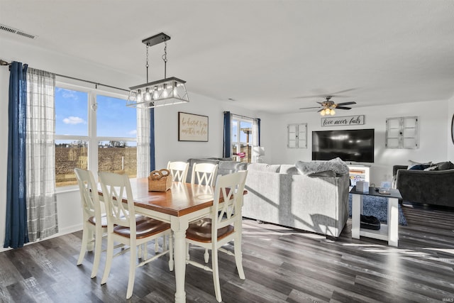 dining area with a ceiling fan, visible vents, and dark wood finished floors