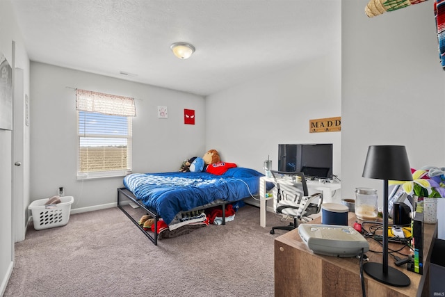 bedroom featuring a textured ceiling, carpet floors, visible vents, and baseboards