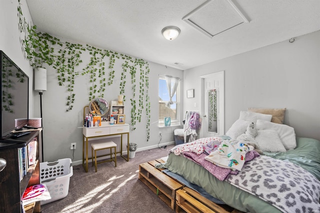 bedroom with attic access, dark colored carpet, and baseboards