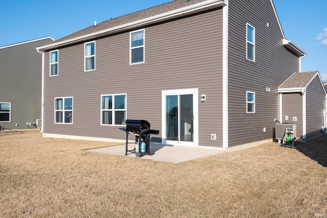 rear view of property featuring a patio, central AC unit, and a lawn