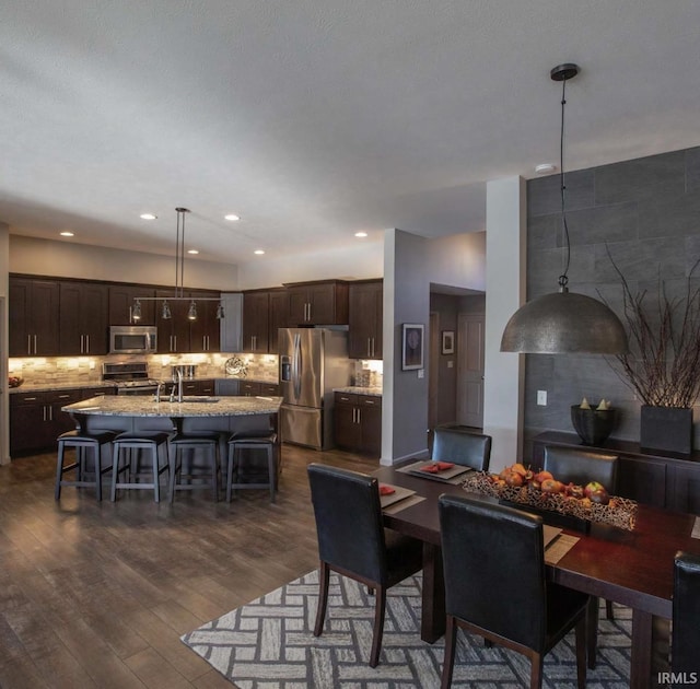 dining area with dark wood-style floors and recessed lighting