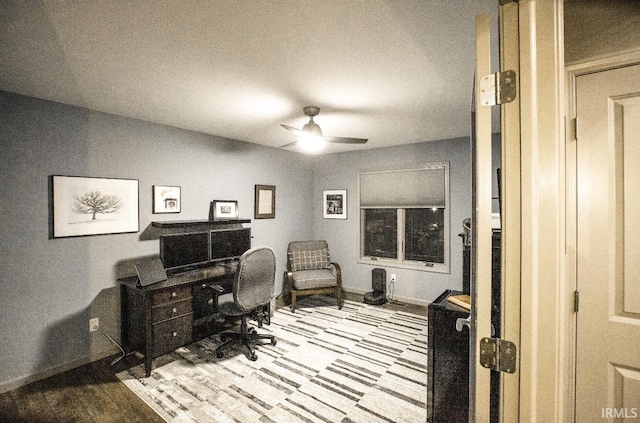 office featuring a ceiling fan and baseboards