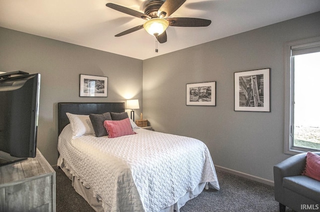 bedroom featuring ceiling fan, dark colored carpet, and baseboards