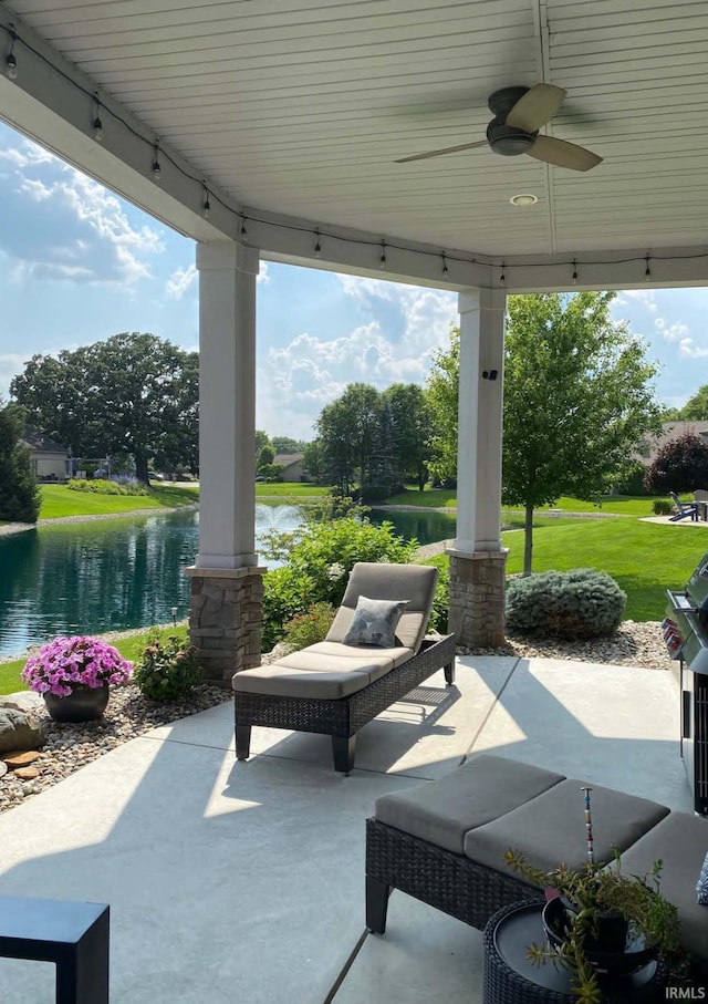 view of patio / terrace with a water view and ceiling fan