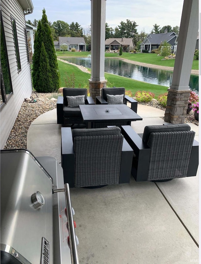 view of patio / terrace featuring a residential view, a water view, and outdoor dining space