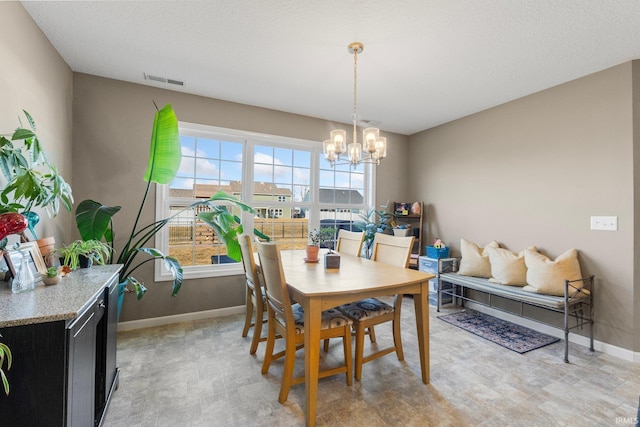 dining room with visible vents, a notable chandelier, and baseboards