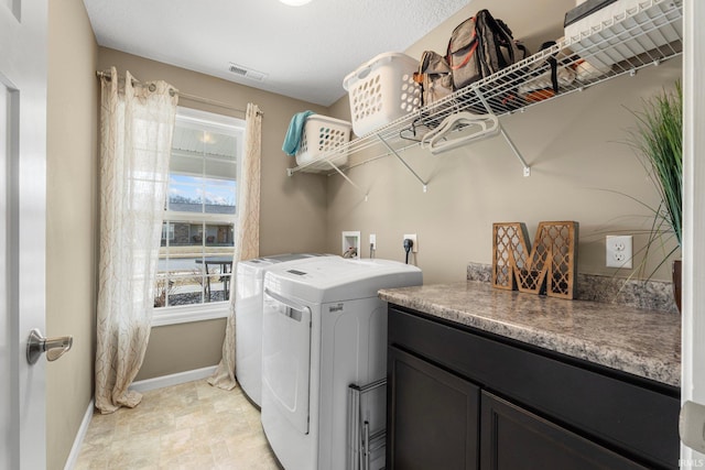 clothes washing area with laundry area, baseboards, visible vents, washing machine and clothes dryer, and a textured ceiling