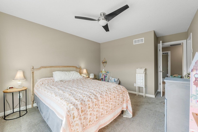 bedroom featuring a ceiling fan, visible vents, light carpet, and baseboards