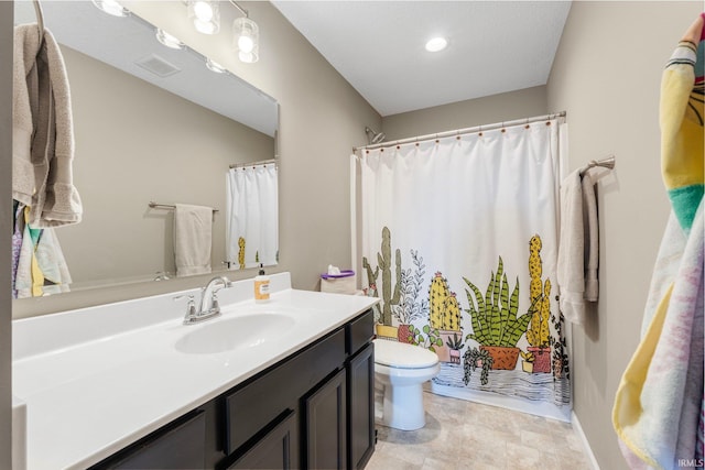 full bathroom featuring toilet, vanity, and visible vents