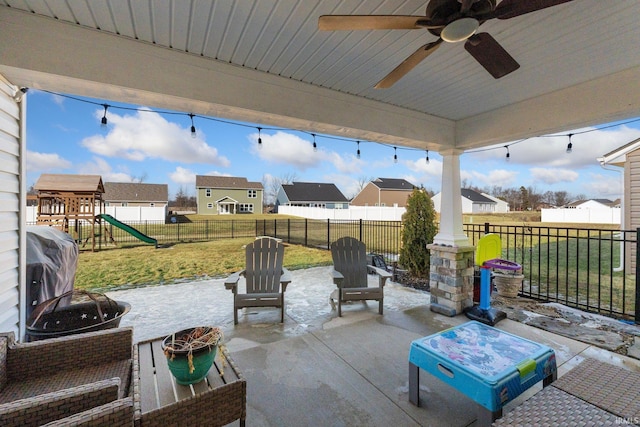 view of patio with area for grilling, a playground, a fenced backyard, and a residential view