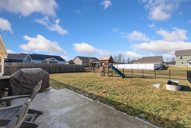 view of yard with a playground, a fenced backyard, and a residential view