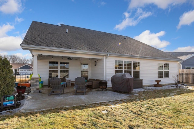 rear view of property featuring a patio, a shingled roof, a lawn, ceiling fan, and fence