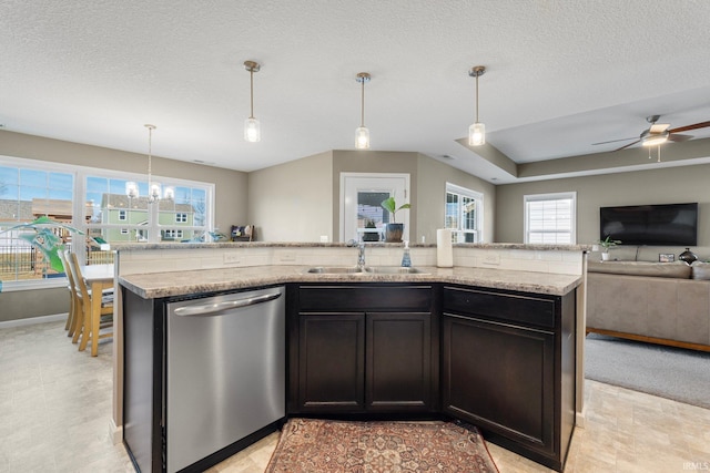 kitchen with hanging light fixtures, open floor plan, a sink, an island with sink, and dishwasher