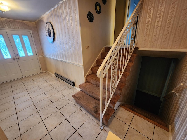 foyer with wallpapered walls, ornamental molding, tile patterned flooring, stairs, and a baseboard heating unit