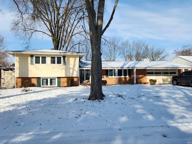 tri-level home featuring brick siding and a chimney