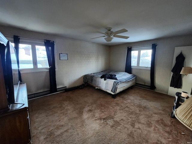 unfurnished bedroom featuring dark colored carpet, a baseboard radiator, and a ceiling fan