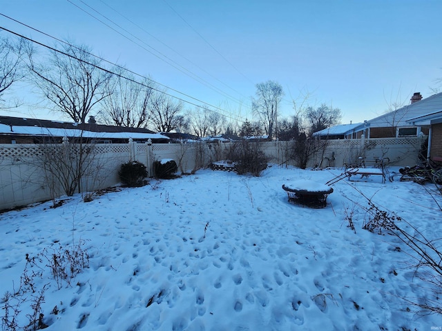 yard covered in snow featuring fence