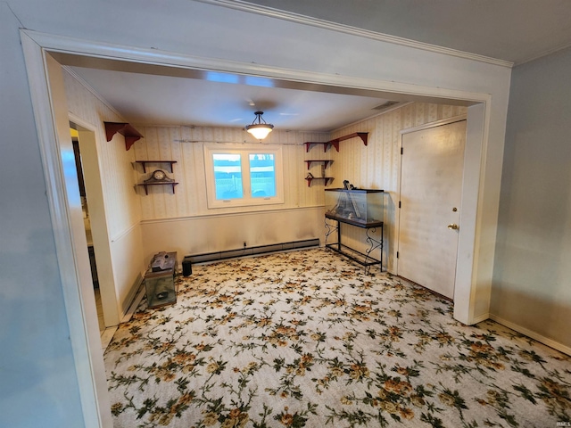 interior space featuring carpet floors, crown molding, a baseboard radiator, visible vents, and baseboards