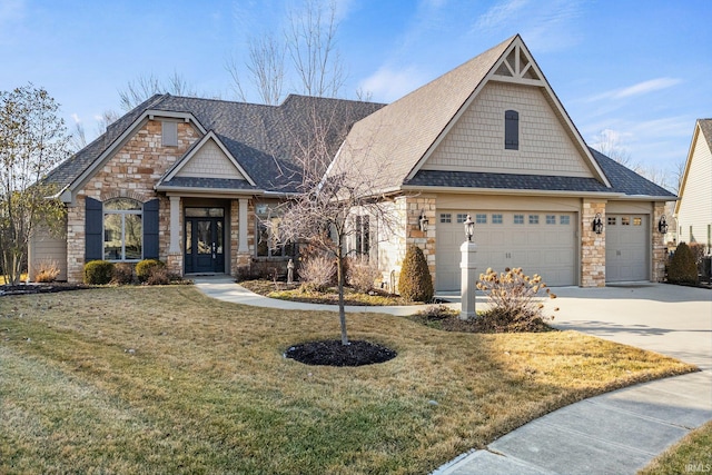 craftsman-style house with a front yard, stone siding, roof with shingles, and concrete driveway