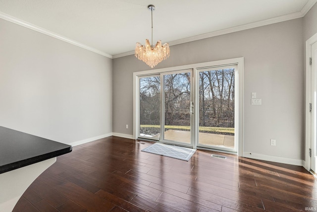 unfurnished dining area featuring dark wood-style floors, ornamental molding, and baseboards