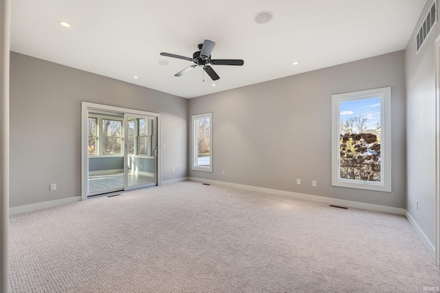 spare room featuring light carpet, baseboards, and visible vents