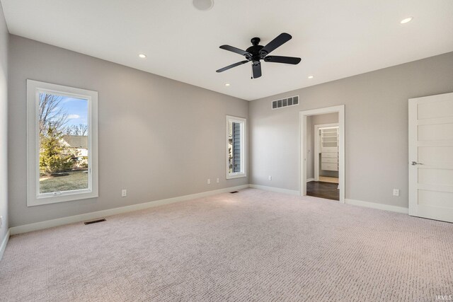 unfurnished bedroom with light carpet, baseboards, visible vents, and recessed lighting