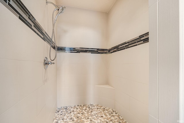 bathroom with tiled shower