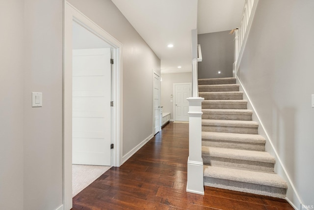 stairs featuring recessed lighting, wood-type flooring, and baseboards