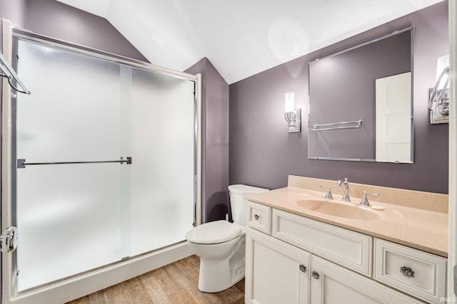 full bathroom with a stall shower, lofted ceiling, vanity, and wood finished floors