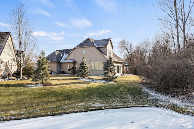 view of snow covered exterior featuring a lawn