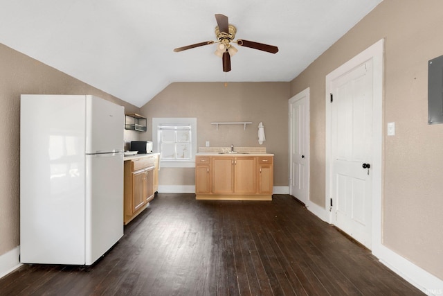 kitchen featuring dark wood finished floors, lofted ceiling, light countertops, light brown cabinetry, and freestanding refrigerator