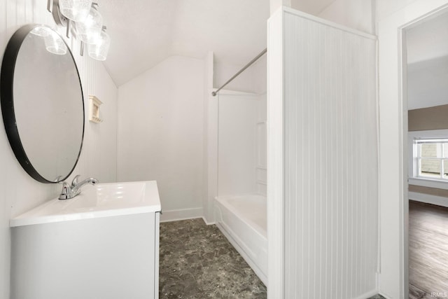 full bathroom featuring vaulted ceiling, vanity, baseboards, and shower / bathtub combination