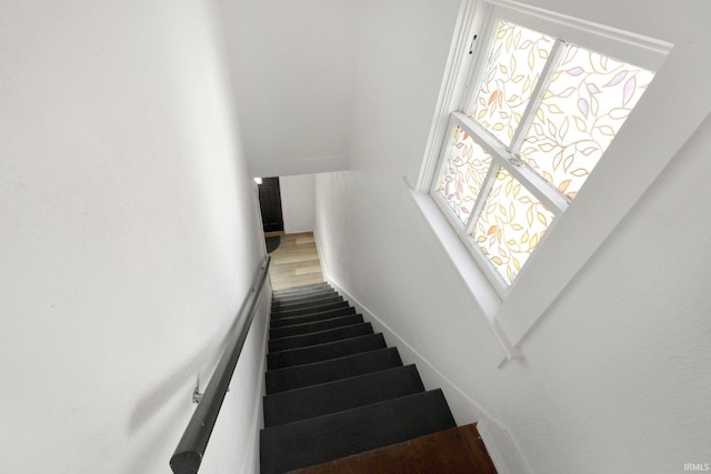 stairway featuring wood finished floors