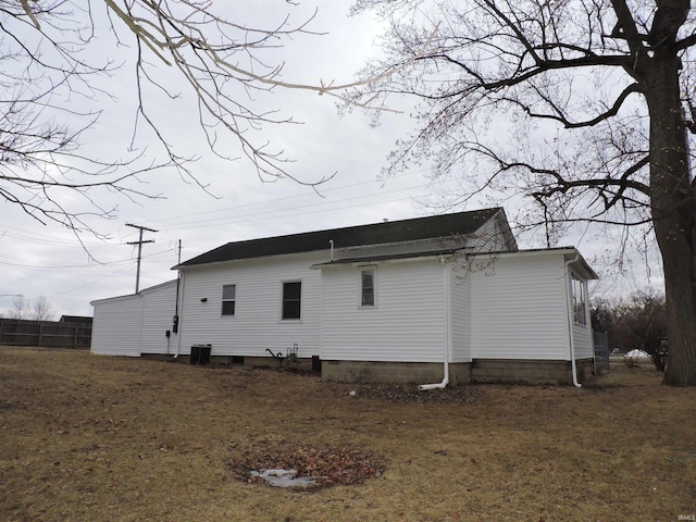 view of side of home with central AC unit