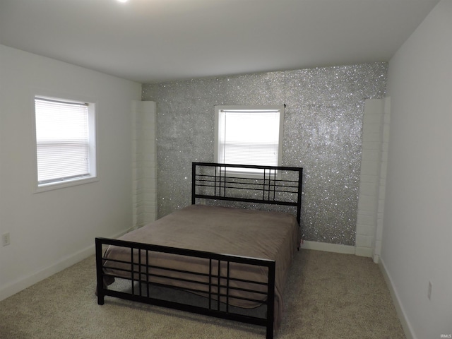 bedroom with carpet floors and baseboards