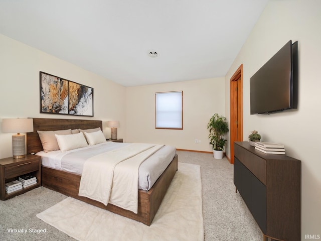 bedroom with light colored carpet, visible vents, and baseboards