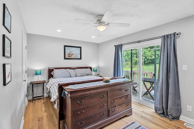 bedroom with access to exterior, visible vents, light wood finished floors, and a textured ceiling